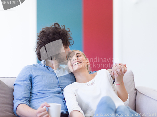 Image of Young couple on the sofa watching television