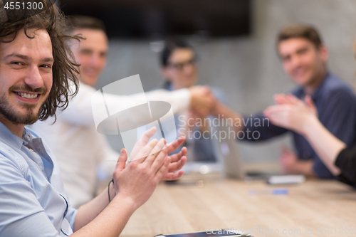 Image of cloasing the deal in modern office interior