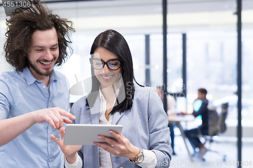 Image of Business People Working With Tablet in startup office