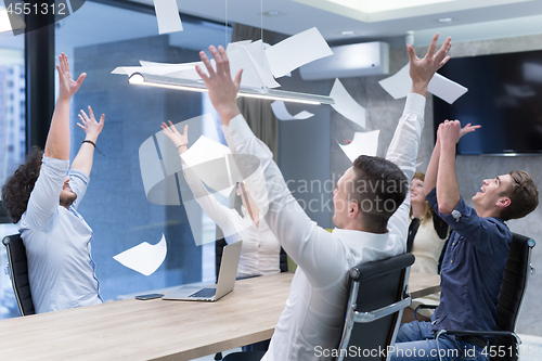 Image of startup Group of young business people throwing documents