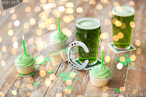 Image of glass of beer, cupcakes, horseshoe and gold coins