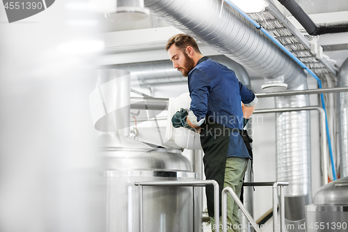 Image of man working at craft brewery or beer plant