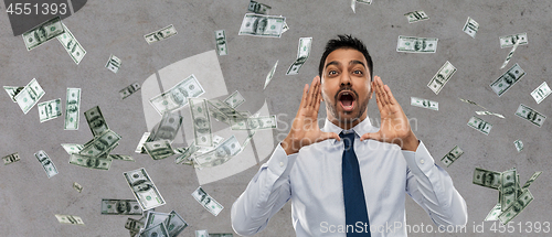 Image of indian businessman shouting over money rain