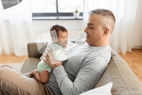 Image of happy father with little baby boy at home