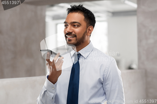 Image of businessman using voice command on smartphone