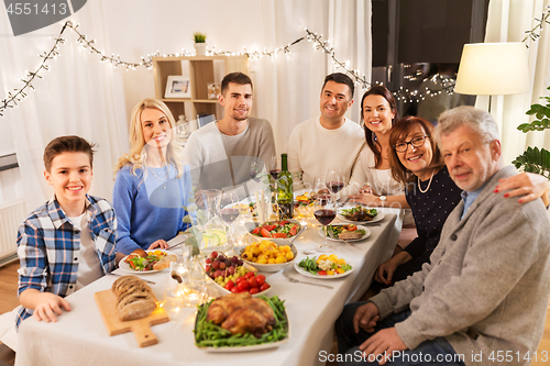 Image of happy family having dinner party at home