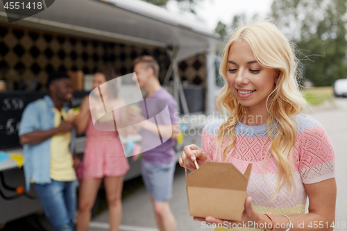 Image of happy woman with wok and friends at food truck