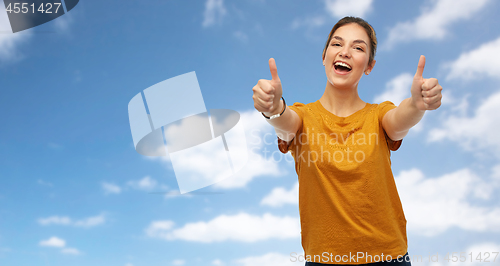 Image of woman or teenage girl in t-shirt showing thumbs up