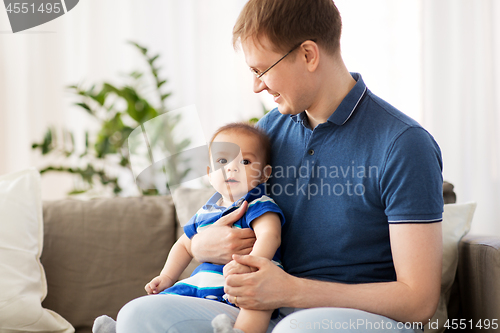 Image of happy father with baby son at home