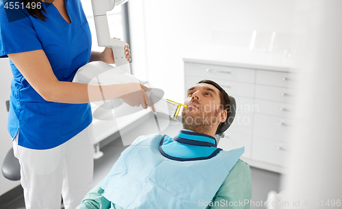 Image of dentist making dental x-ray of patient teeth