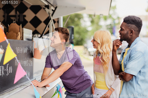 Image of happy customers queue or friends at food truck