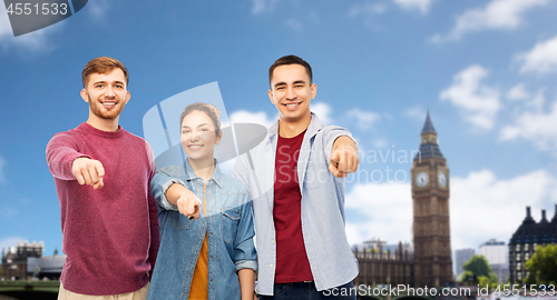 Image of smiling friends pointing at you over london