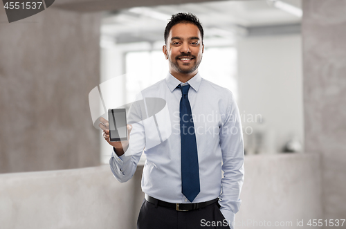 Image of indian businessman with smartphone at office