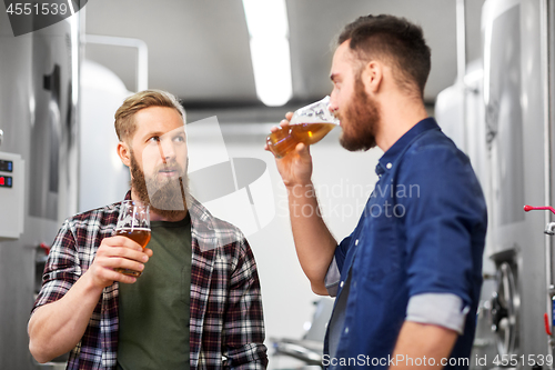 Image of men drinking and testing craft beer at brewery