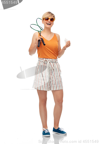 Image of teenager with badminton rackets and shuttlecock