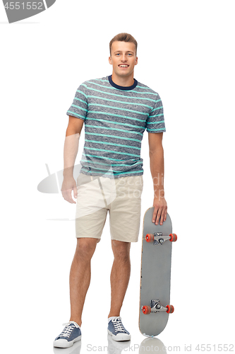 Image of smiling young man with skateboard over white