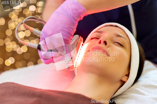 Image of young woman having face microdermabrasion at spa