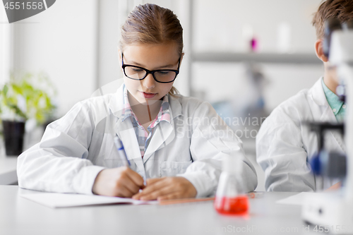 Image of girl studying chemistry at school laboratory