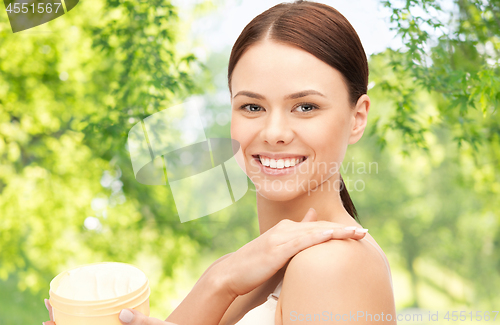 Image of beautiful woman with moisturizing cream