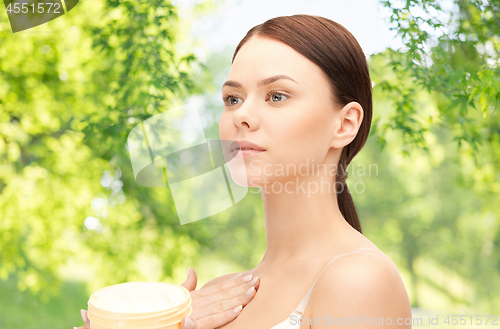 Image of beautiful woman with moisturizing cream