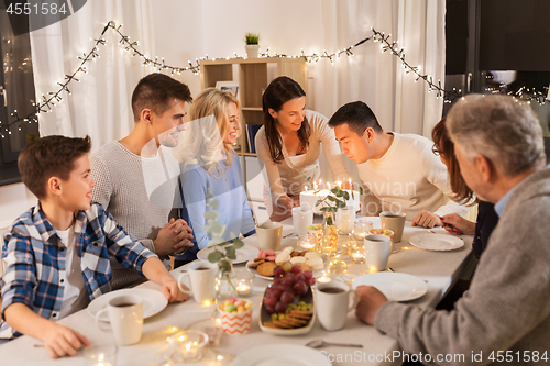 Image of happy family having birthday party at home