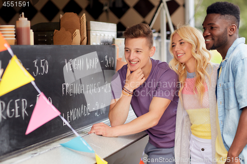 Image of happy customers or friends at food truck