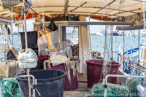 Image of The fishing boat\'s interior, the right side of the boat, the fishing tools, the fishing industry, the rusting cabin