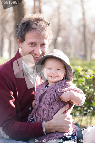 Image of Father with cheerful child in the park.