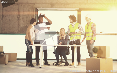 Image of group of multiethnic business people on construction site