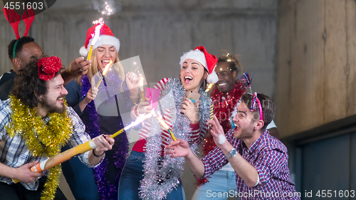 Image of multiethnic group of casual business people dancing with sparkle