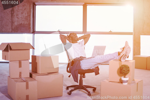 Image of young black casual businessman taking a break on construction si