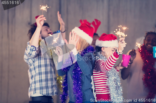 Image of multiethnic group of casual business people dancing with sparkle