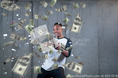 Image of black businessman making the rain of money