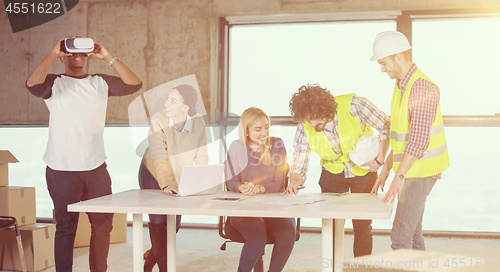 Image of group of multiethnic business people on construction site