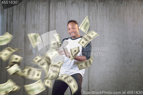 Image of black businessman making the rain of money