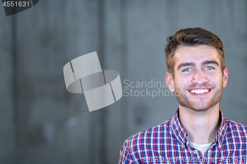 Image of portrait of casual businessman in front of a concrete wall