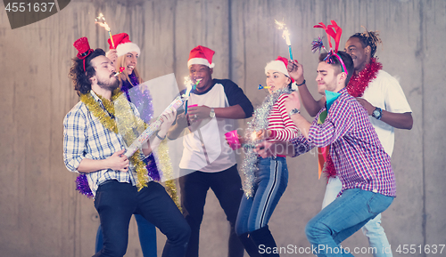 Image of multiethnic group of casual business people dancing with sparkle