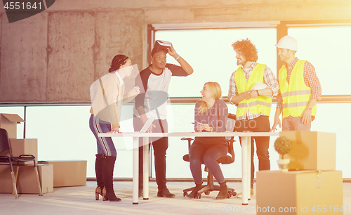 Image of group of multiethnic business people on construction site