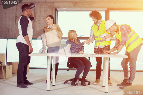 Image of group of multiethnic business people on construction site