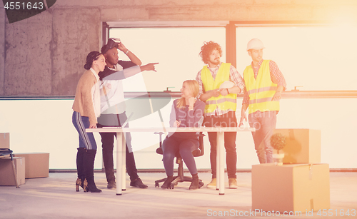 Image of group of multiethnic business people on construction site