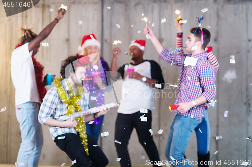 Image of multiethnic group of casual business people having confetti part