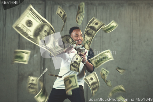 Image of black businessman making the rain of money