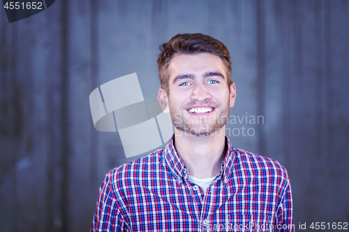 Image of portrait of casual businessman in front of a concrete wall