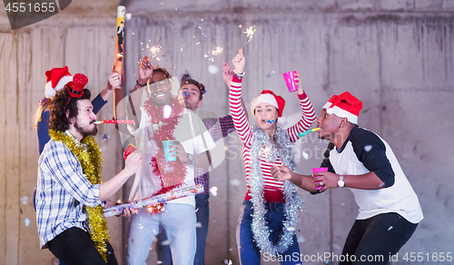 Image of multiethnic group of casual business people having confetti part