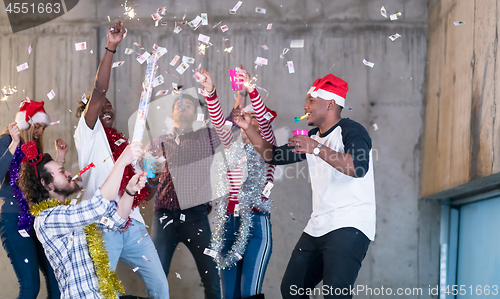 Image of multiethnic group of casual business people having confetti part