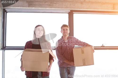 Image of business team carrying cardboard boxes