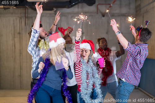 Image of multiethnic group of casual business people dancing with sparkle