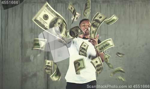 Image of black businessman making the rain of money