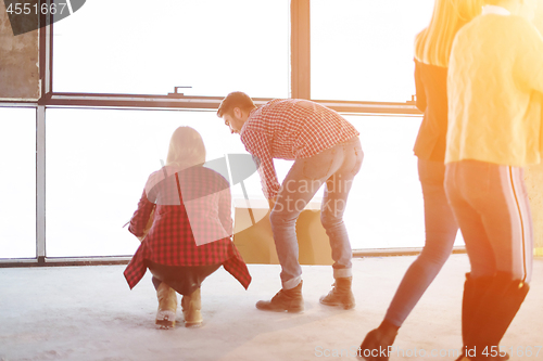 Image of business team carrying cardboard boxes