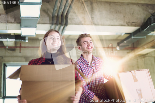 Image of business team carrying cardboard boxes